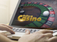 a man playing roulette at an online casino. The white ball has landed on number 26.