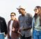 four young people enjoying a walk in town together