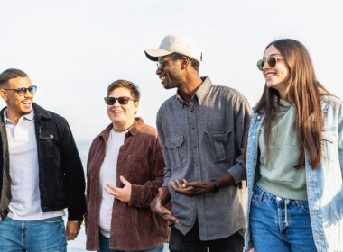 four young people enjoying a walk in town together