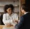 two young people, a man and a woman, shake hands as one has given the other some good advice