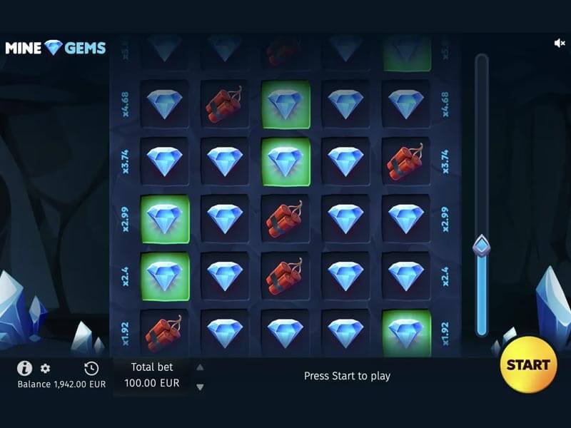 Screenshot of the 'Mine Gems' online slot game featuring a 5x5 grid with blue diamond gem symbols and red dynamite icons. The game interface displays multipliers like x1.92, x2.4, and x3.74 on the left side, indicating potential payout increases. The player's balance shows 1,942.00 EUR with a total bet of 100.00 EUR. A prominent yellow 'START' button is located on the bottom right. The game is set in a dark, cave-like environment, reflecting a mining theme.