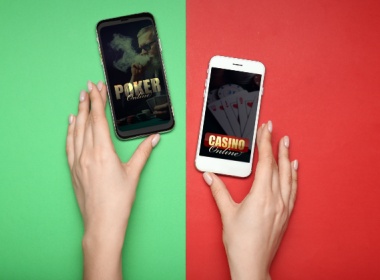 a woman's hands with two smartphones. On one is the word poker and on the other is the word casino.