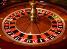 Overhead view of a beautiful roulette wheel at a European Roulette game. The wood of the wheel is stunning.