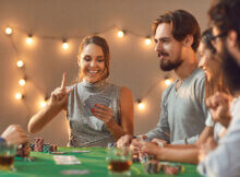 a mixed group of young adults enjoying playing card games together