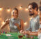 a mixed group of young adults enjoying playing card games together