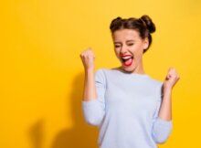 a young woman with a Pricess Lea hairdo exhilarating possibly because she won at an online casino